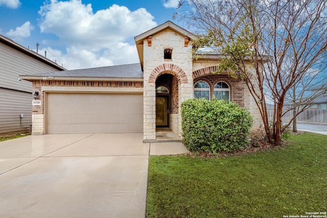 view of front of house with a garage and a front lawn