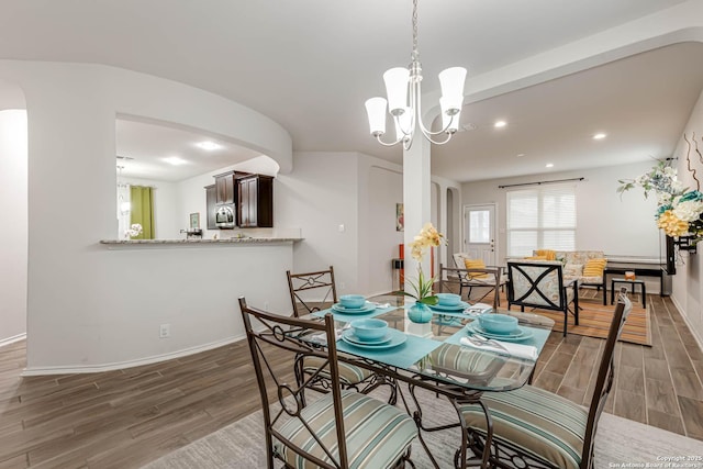 dining room featuring an inviting chandelier and dark hardwood / wood-style flooring