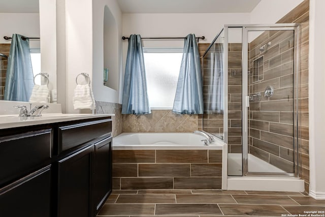 bathroom featuring vanity and shower with separate bathtub