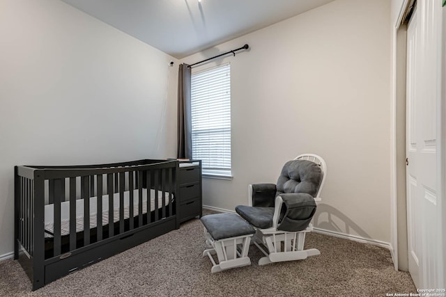 bedroom with a crib and carpet flooring