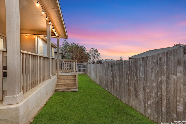 view of yard at dusk