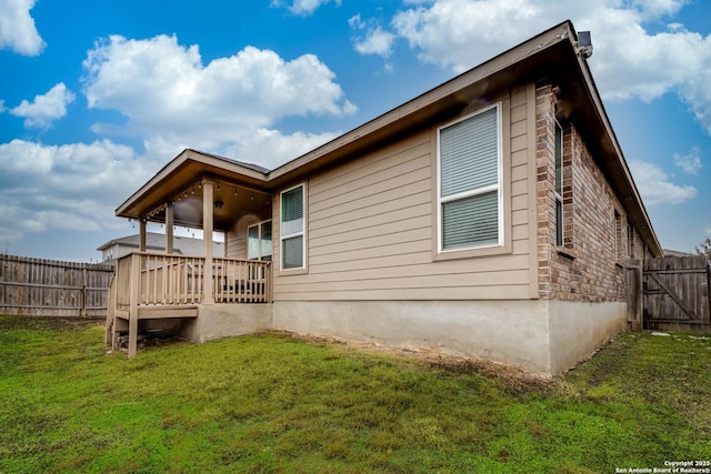 back of property featuring a lawn