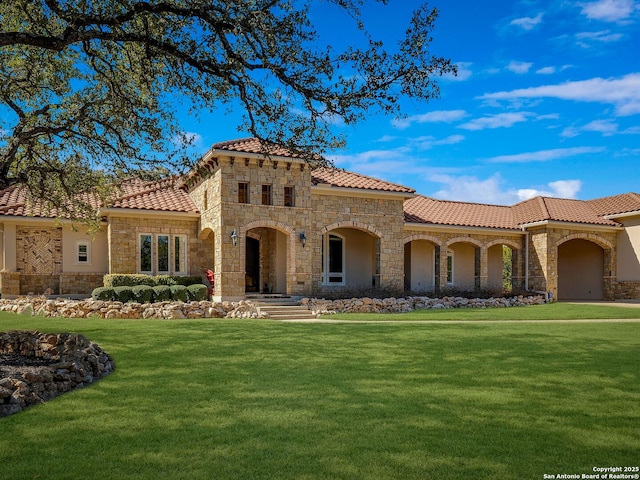 mediterranean / spanish home with a front lawn