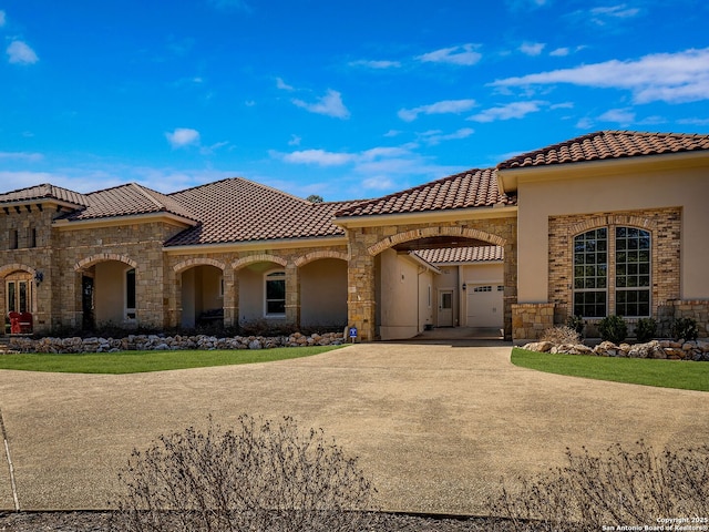 mediterranean / spanish-style house with a garage