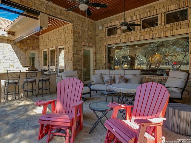 view of patio featuring outdoor lounge area, ceiling fan, and exterior bar