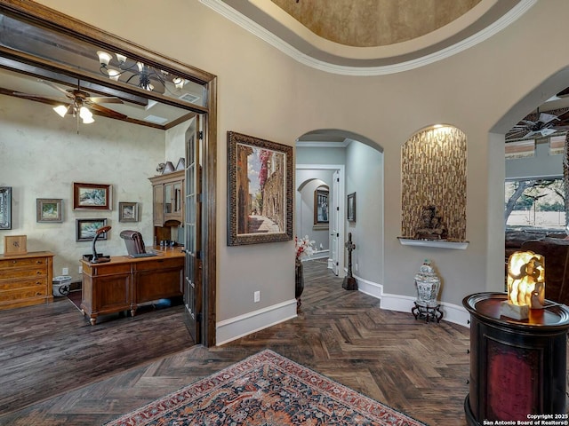 hallway featuring ornamental molding, dark parquet floors, and a high ceiling