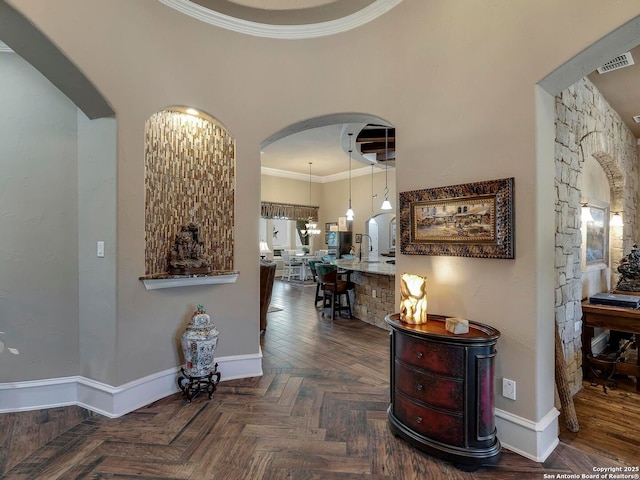 hall with crown molding and dark parquet flooring