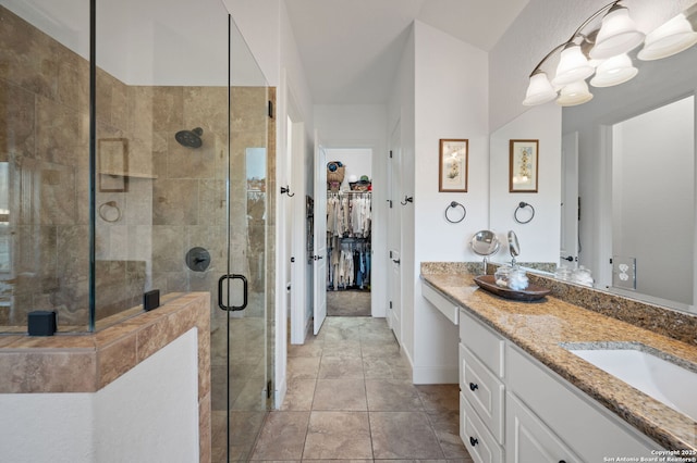 bathroom with vanity, tile patterned floors, and a shower with shower door