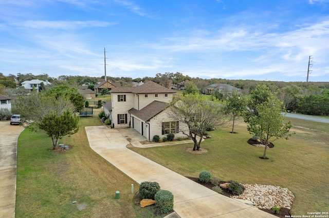 view of front of property featuring a garage and a front lawn