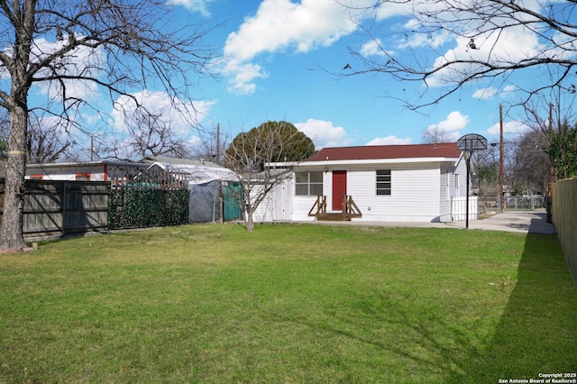 rear view of property featuring a yard