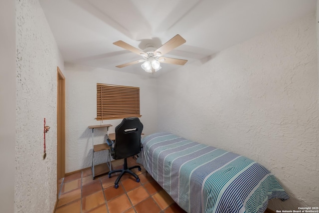 tiled bedroom with ceiling fan