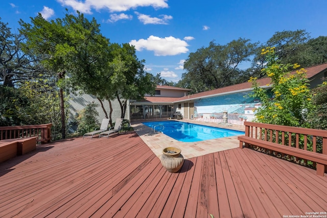 view of swimming pool with a wooden deck