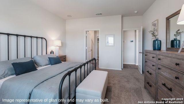 bedroom featuring carpet floors, baseboards, and visible vents