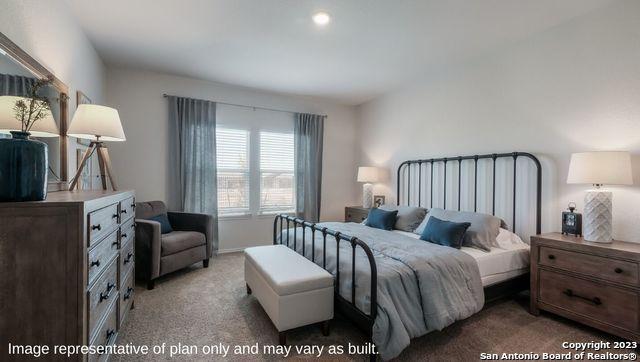 bedroom featuring light carpet