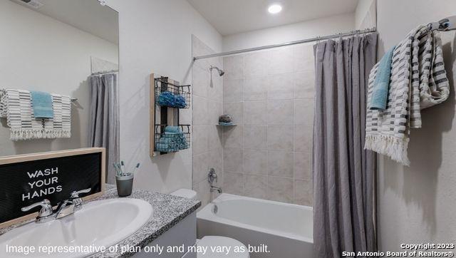 full bath featuring vanity, visible vents, toilet, and shower / tub combo