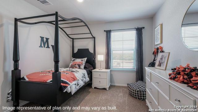 bedroom with visible vents, carpet floors, and multiple windows