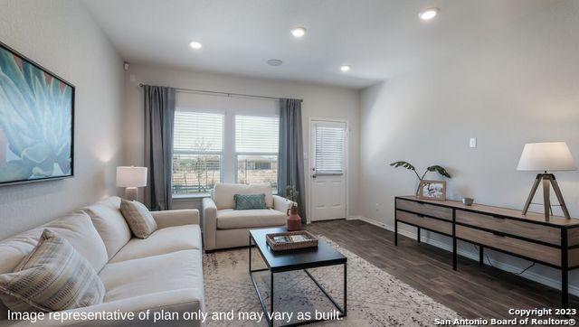 living area with recessed lighting, baseboards, and wood finished floors