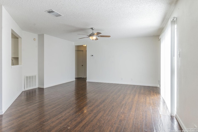 empty room featuring ceiling fan, dark hardwood / wood-style flooring, and a textured ceiling