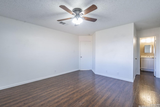 unfurnished room with ceiling fan, dark hardwood / wood-style floors, and a textured ceiling