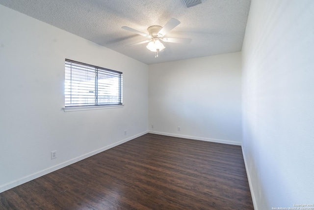 empty room featuring ceiling fan, dark hardwood / wood-style flooring, and a textured ceiling