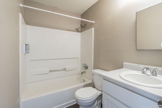 full bathroom featuring vanity, washtub / shower combination, a textured ceiling, and toilet