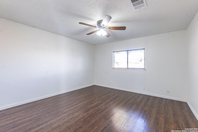 empty room with dark hardwood / wood-style floors, a textured ceiling, and ceiling fan