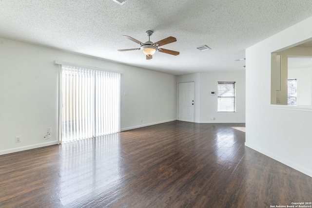 unfurnished room with a textured ceiling, dark hardwood / wood-style floors, and ceiling fan