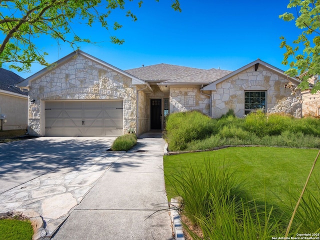 ranch-style home with a garage and a front lawn