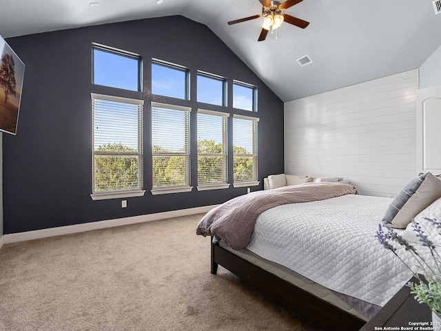 carpeted bedroom with high vaulted ceiling and ceiling fan