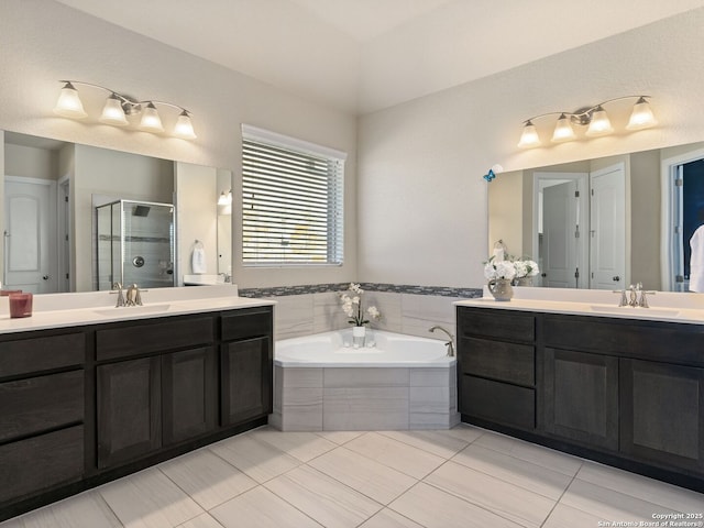 bathroom with vanity and separate shower and tub