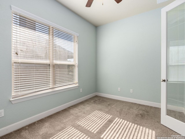 empty room with light colored carpet and ceiling fan