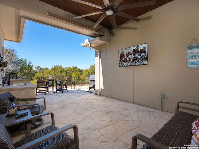 view of patio / terrace with ceiling fan, grilling area, and sink