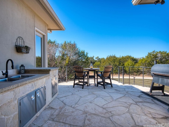 view of patio with exterior kitchen and sink