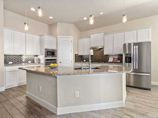 kitchen with white cabinetry, decorative light fixtures, stainless steel appliances, and a center island with sink