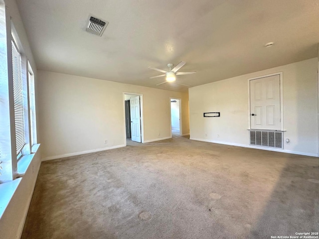 empty room with ceiling fan and carpet