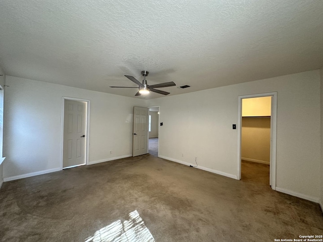 interior space featuring carpet, a textured ceiling, and ceiling fan