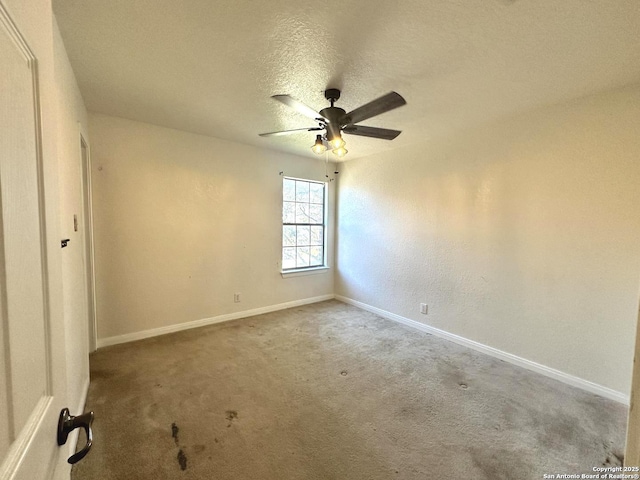 carpeted empty room with a textured ceiling and ceiling fan