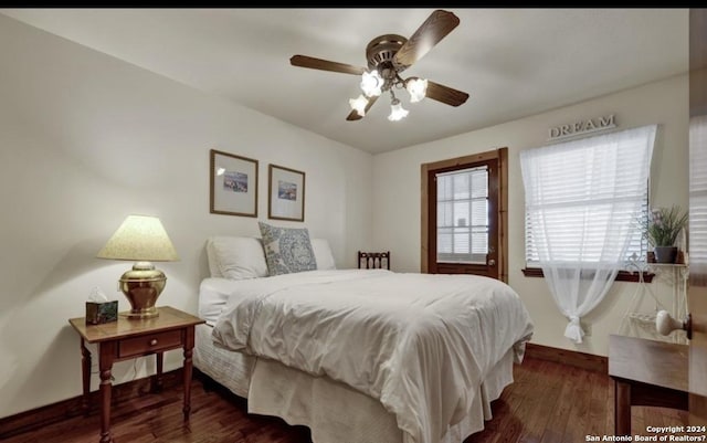 bedroom with dark hardwood / wood-style floors and ceiling fan