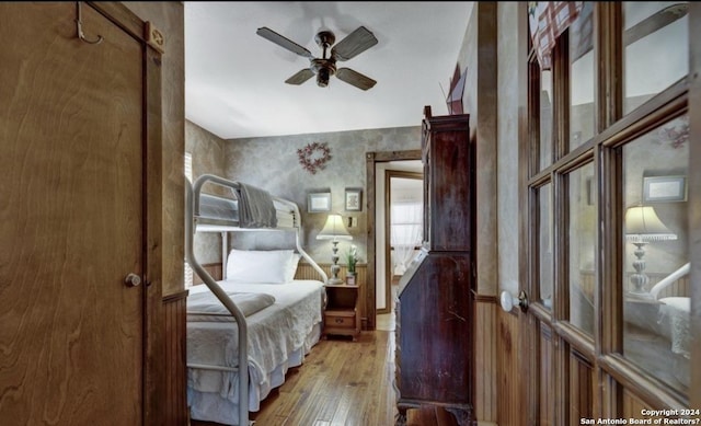 bedroom with light hardwood / wood-style floors and ceiling fan