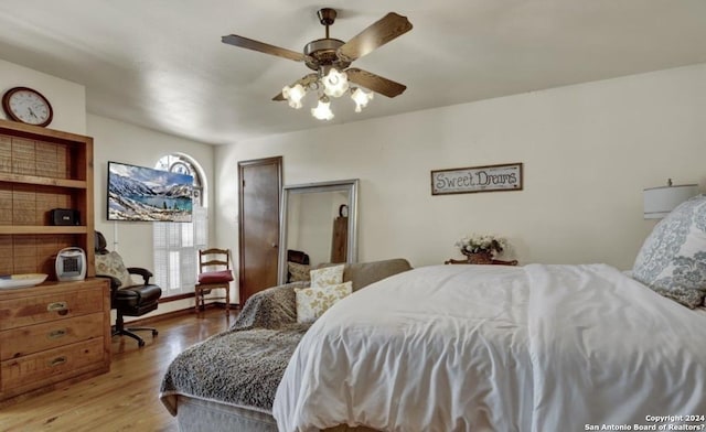 bedroom with ceiling fan and light hardwood / wood-style floors