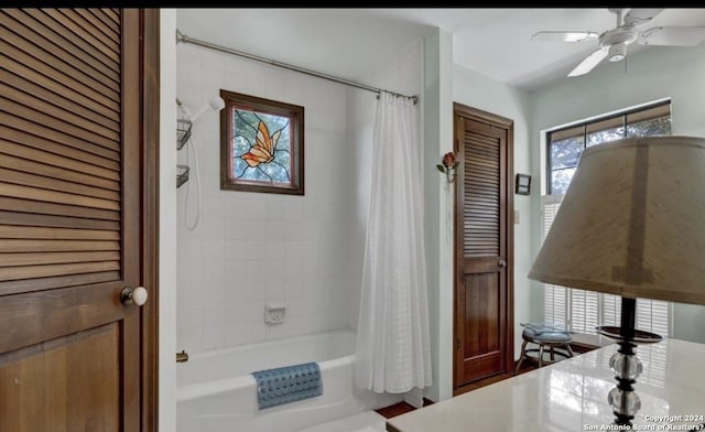 bathroom with shower / bath combination with curtain and ceiling fan