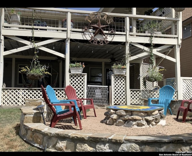 view of patio / terrace with ceiling fan and an outdoor fire pit