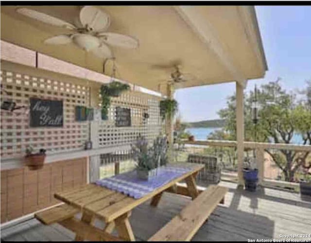 wooden terrace featuring ceiling fan