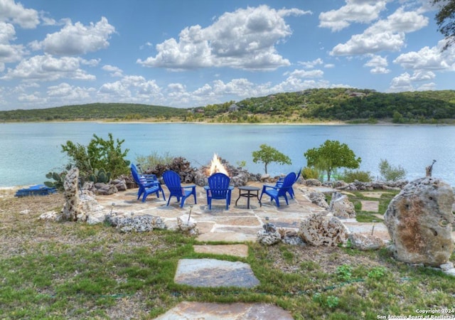 property view of water featuring an outdoor fire pit