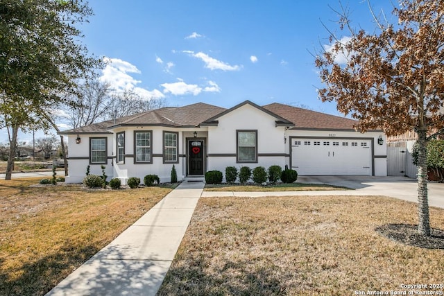 ranch-style home with a garage and a front yard