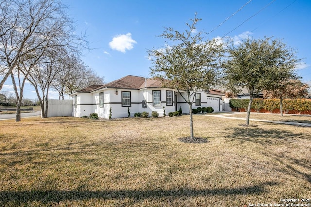 view of front facade featuring a garage and a front lawn