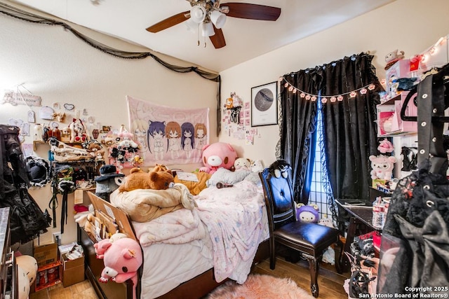 bedroom with ceiling fan and hardwood / wood-style floors