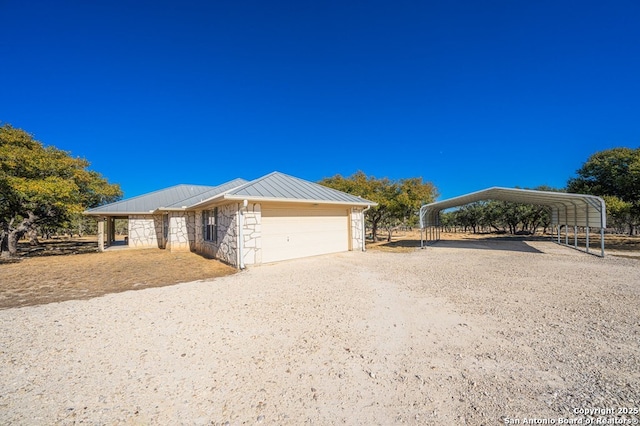 view of front of house with a carport and a garage