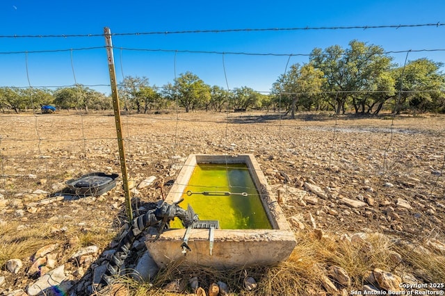 view of storm shelter with a rural view