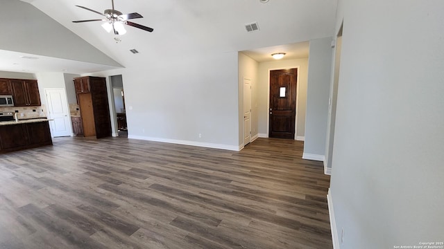 unfurnished living room featuring ceiling fan, dark hardwood / wood-style flooring, and high vaulted ceiling